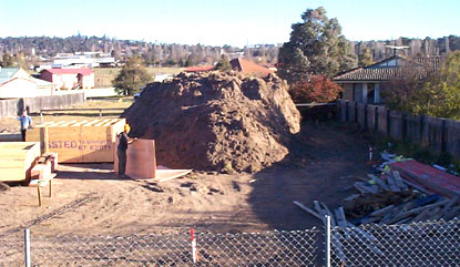 Stored topsoil on building site.